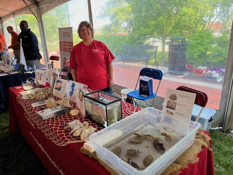Iris Burt, of Haskin Shellfish Research Lab, hosts a table at the Delaware RIver and Bay Authority's (DRBA) 2nd annual World ENvironment Day celebration.