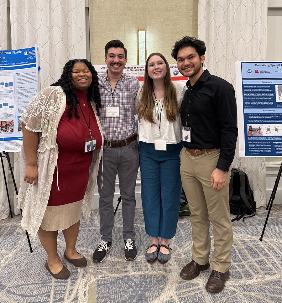 Image shows student presenters at conference receiving awards.