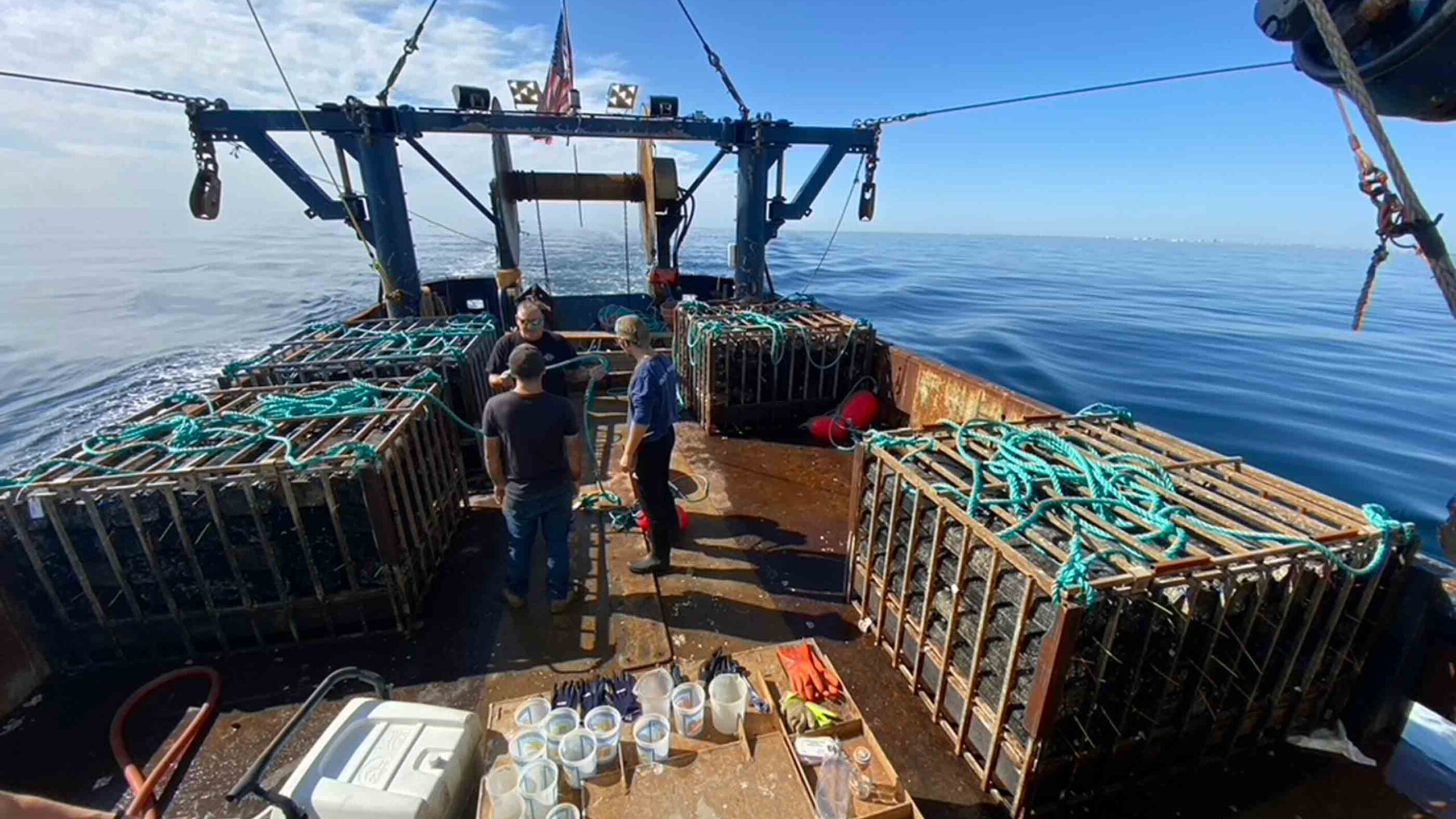stocked cages of surf clams on clam boat ready to deploy